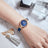 Elegant women's luxury quartz wristwatch with pink mother-of-pearl dial, crystal hour markers, rose gold mesh band, and water resistance