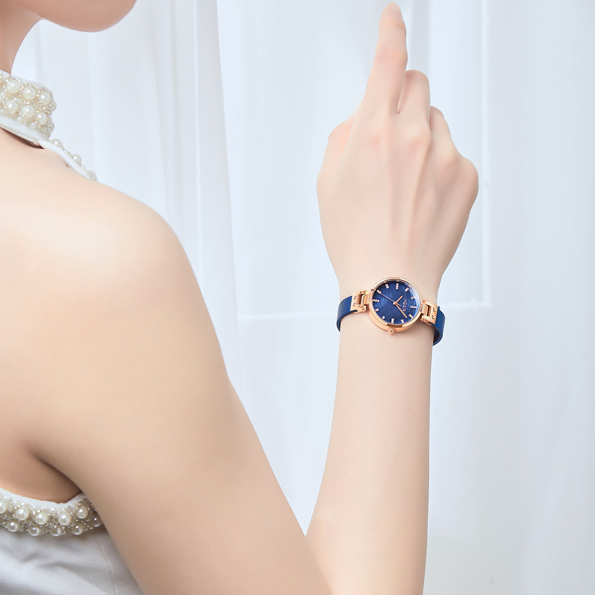 Elegant women's luxury quartz wristwatch with pink mother-of-pearl dial, crystal hour markers, rose gold mesh band, and water resistance