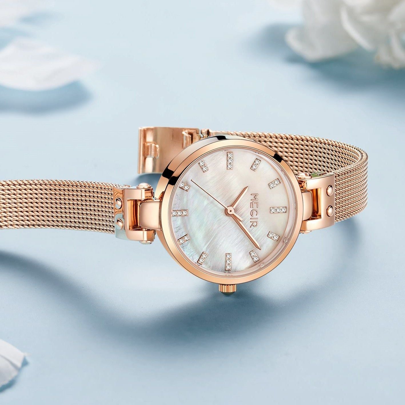 Elegant women's luxury quartz wristwatch with pink mother-of-pearl dial, crystal hour markers, rose gold mesh band, and water resistance