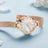 Elegant women's luxury quartz wristwatch with pink mother-of-pearl dial, crystal hour markers, rose gold mesh band, and water resistance