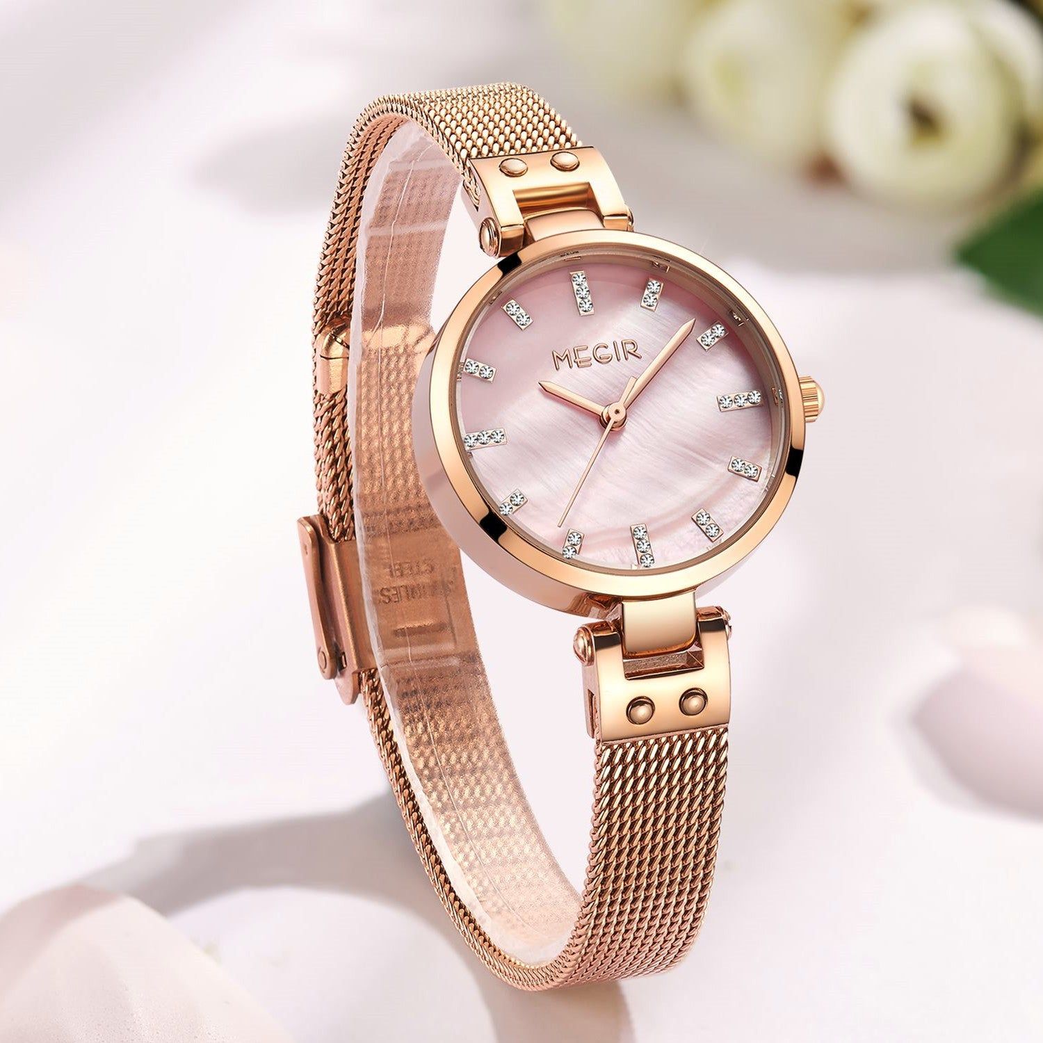 Elegant women's luxury quartz wristwatch with pink mother-of-pearl dial, crystal hour markers, rose gold mesh band, and water resistance