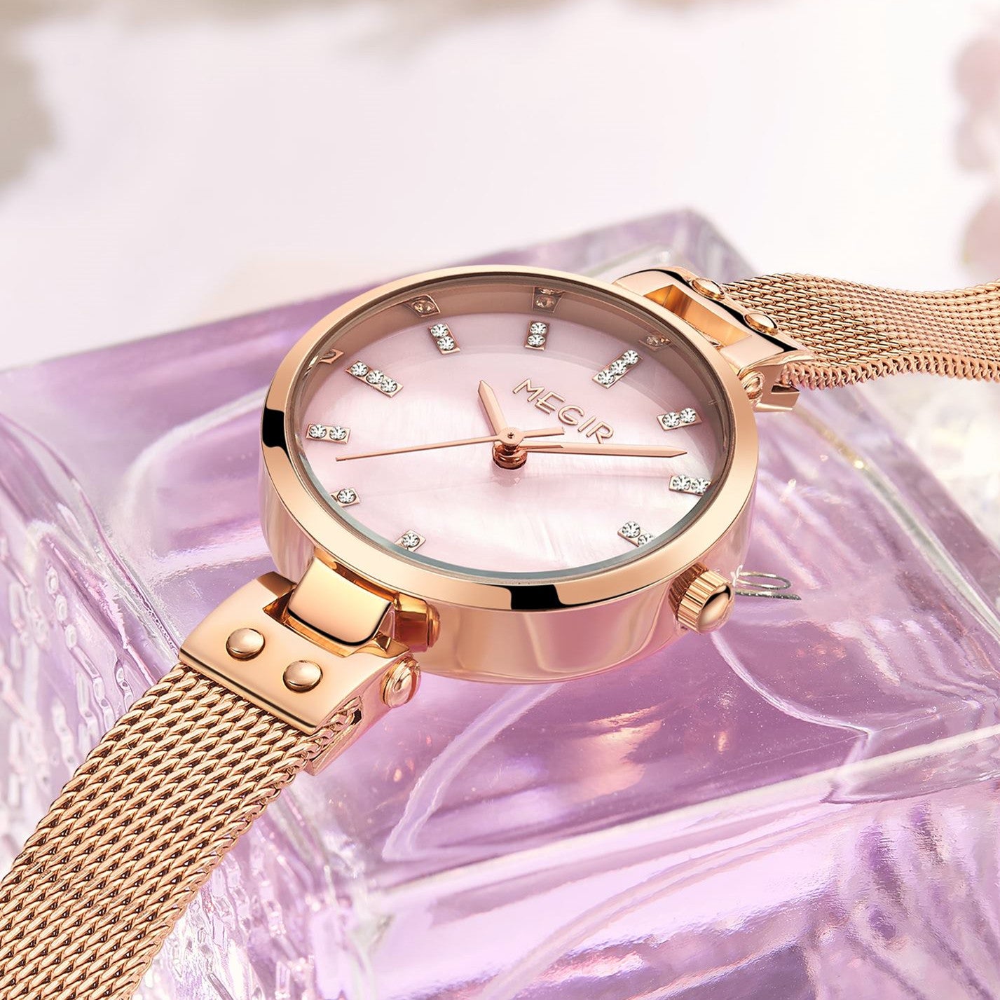 Elegant women's luxury quartz wristwatch with pink mother-of-pearl dial, crystal hour markers, rose gold mesh band, and water resistance
