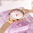 Elegant women's luxury quartz wristwatch with pink mother-of-pearl dial, crystal hour markers, rose gold mesh band, and water resistance