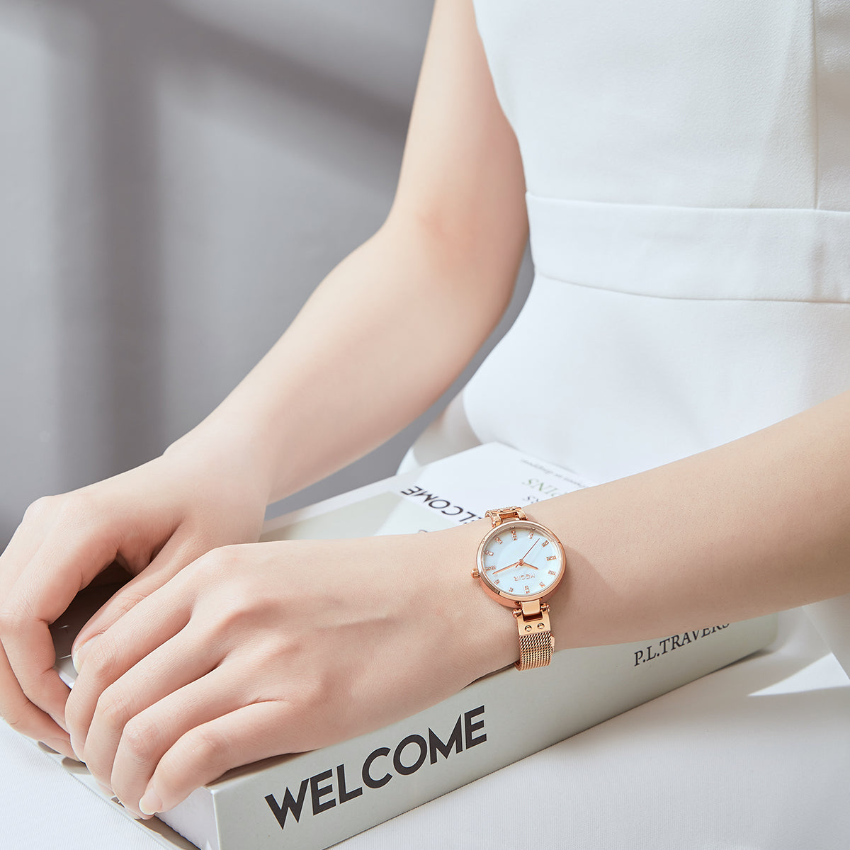 Elegant women's luxury quartz wristwatch with pink mother-of-pearl dial, crystal hour markers, rose gold mesh band, and water resistance