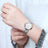 Silver luxury women's quartz bracelet watch with round face, crystal accents, Roman numerals, stainless steel band, elegant design