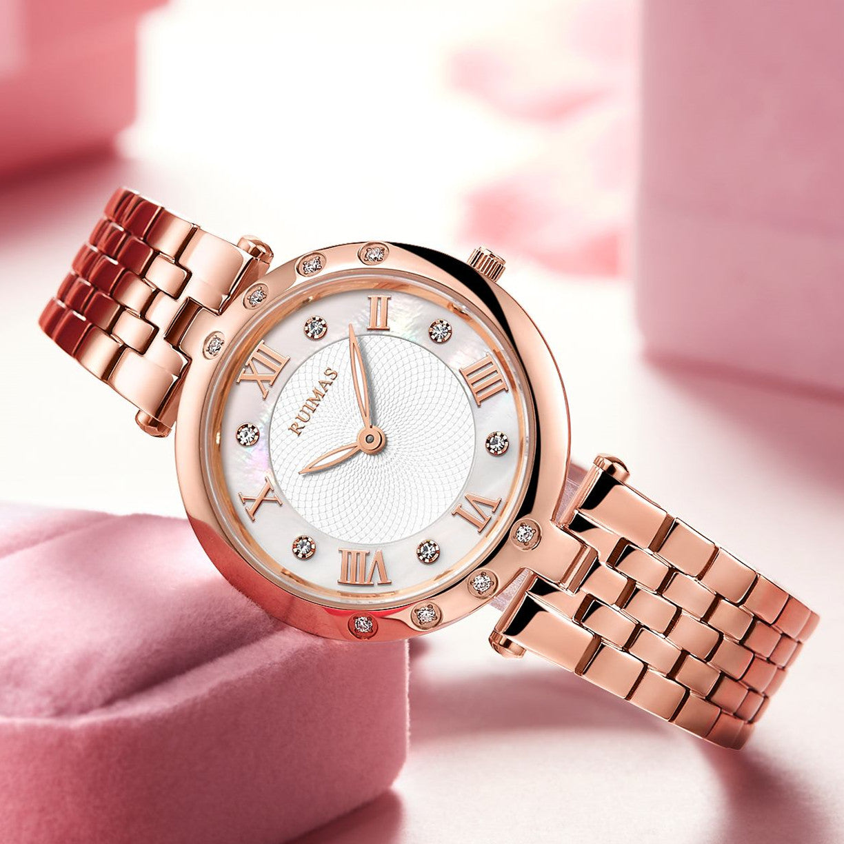Silver luxury women's quartz bracelet watch with round face, crystal accents, Roman numerals, stainless steel band, elegant design
