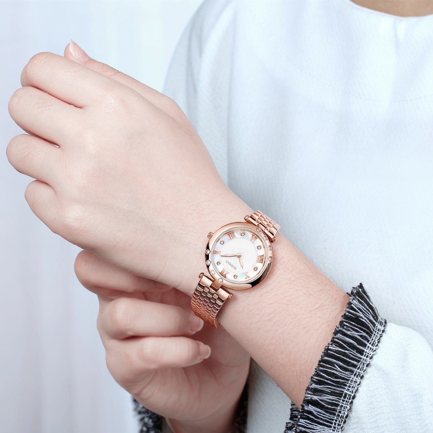 Silver luxury women's quartz bracelet watch with round face, crystal accents, Roman numerals, stainless steel band, elegant design