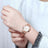 Silver luxury women's quartz bracelet watch with round face, crystal accents, Roman numerals, stainless steel band, elegant design