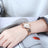 Silver luxury women's quartz bracelet watch with round face, crystal accents, Roman numerals, stainless steel band, elegant design