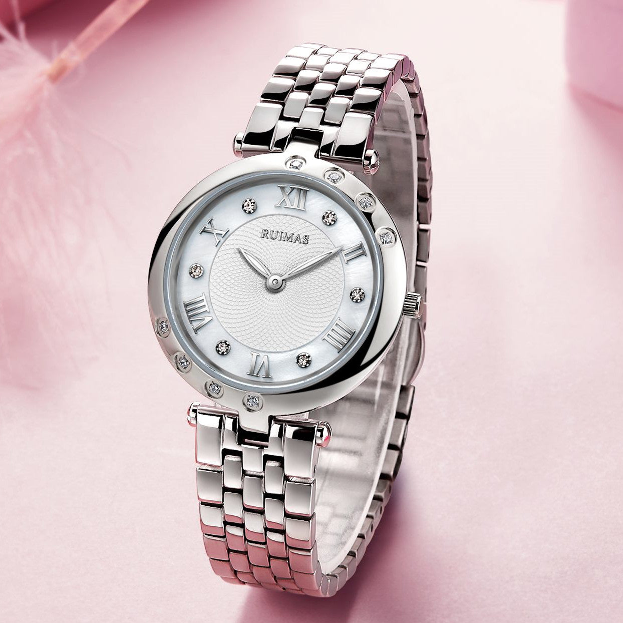 Silver luxury women's quartz bracelet watch with round face, crystal accents, Roman numerals, stainless steel band, elegant design