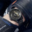 Black men's luxury automatic mechanical watch with a round dial, intricate skeleton design, stainless steel strap, and modern style