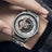 Black men's luxury automatic mechanical watch with a round dial, intricate skeleton design, stainless steel strap, and modern style
