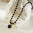 Elegant beaded necklace featuring deep blue lapis lazuli stones and gold accents with a round lapis lazuli pendant, perfect for sophisticated style.