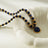 Elegant beaded necklace featuring deep blue lapis lazuli stones and gold accents with a round lapis lazuli pendant, perfect for sophisticated style.