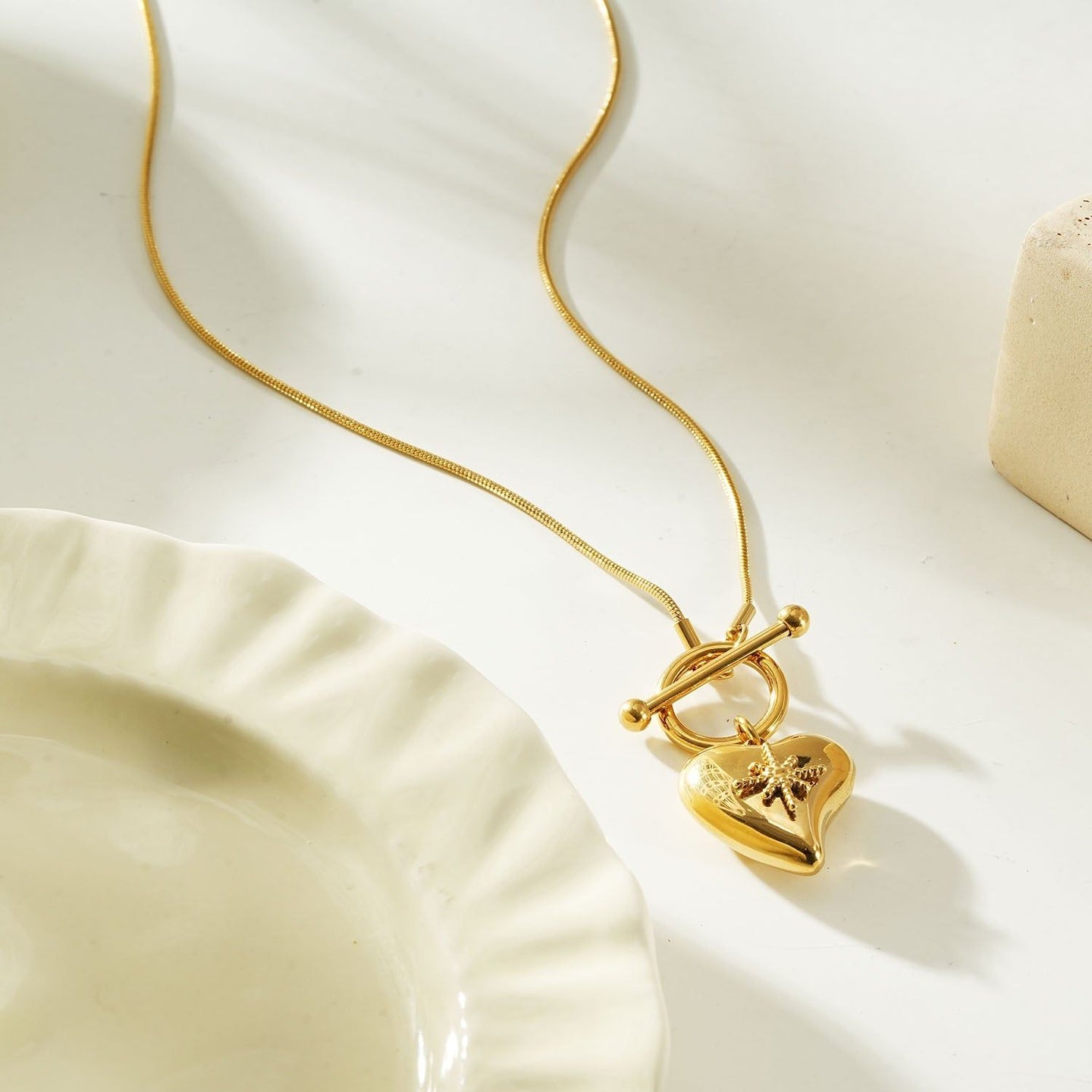 Gold heart toggle pendant necklace with a shiny gold finish, featuring a heart-shaped charm and toggle clasp, perfect for everyday wear or gifting.