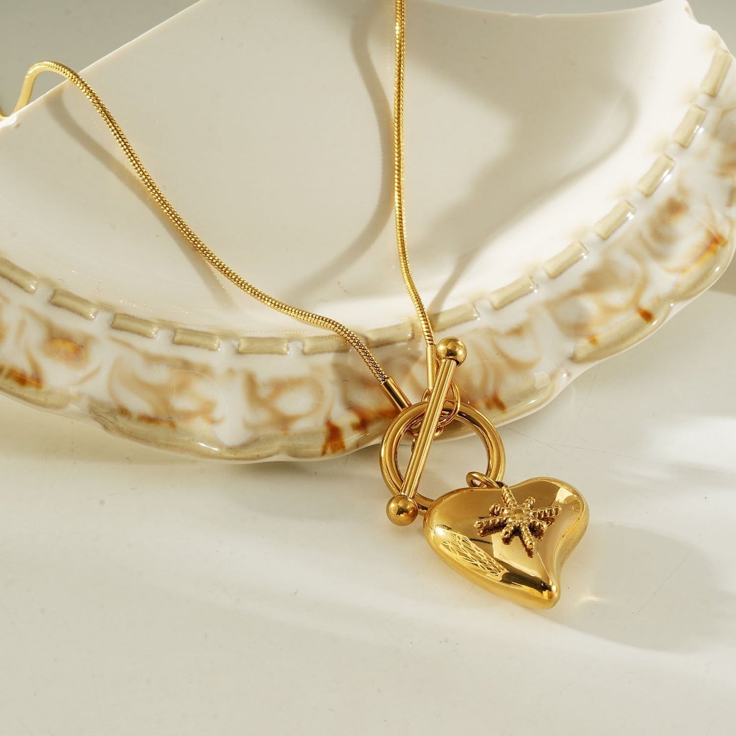 Gold heart toggle pendant necklace with a shiny gold finish, featuring a heart-shaped charm and toggle clasp, perfect for everyday wear or gifting.