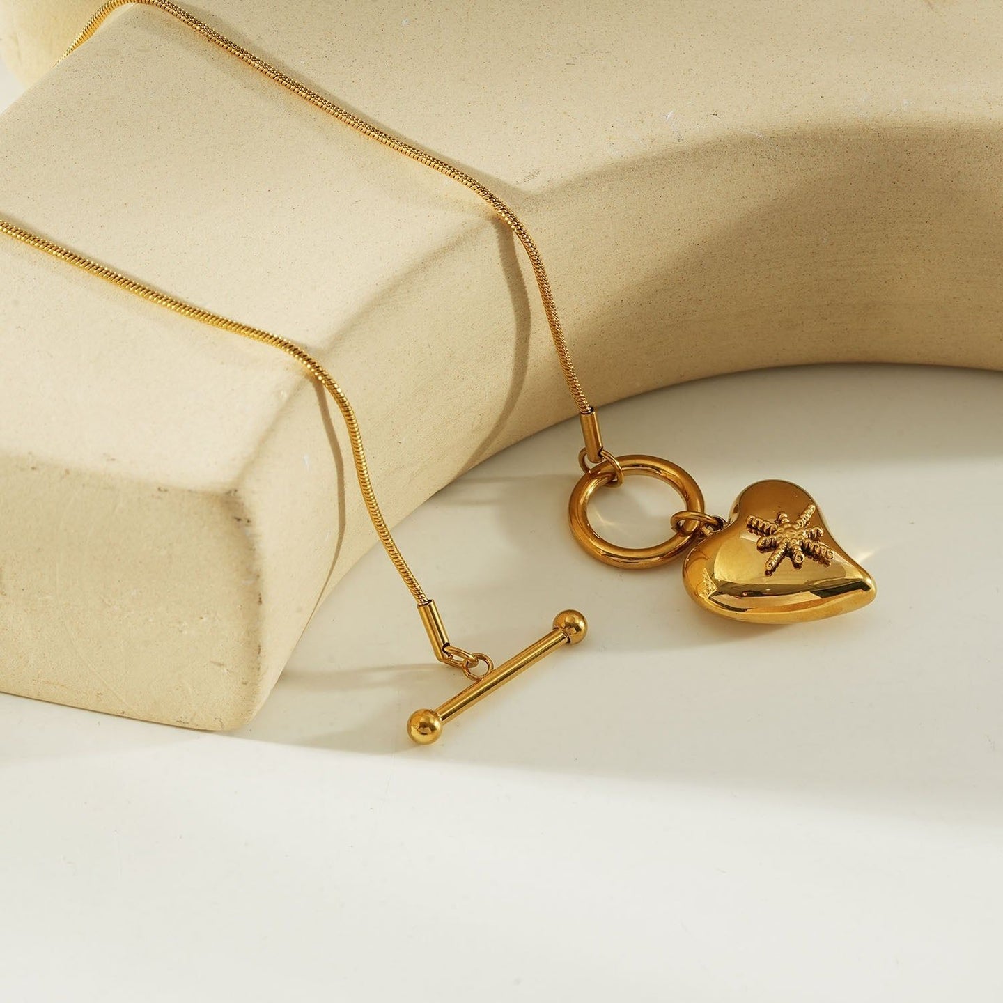 Gold heart toggle pendant necklace with a shiny gold finish, featuring a heart-shaped charm and toggle clasp, perfect for everyday wear or gifting.
