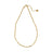 Gold beaded dainty chain necklace with small square beads, resting on a decorative ceramic dish with a scalloped edge, ideal for layering or everyday wear