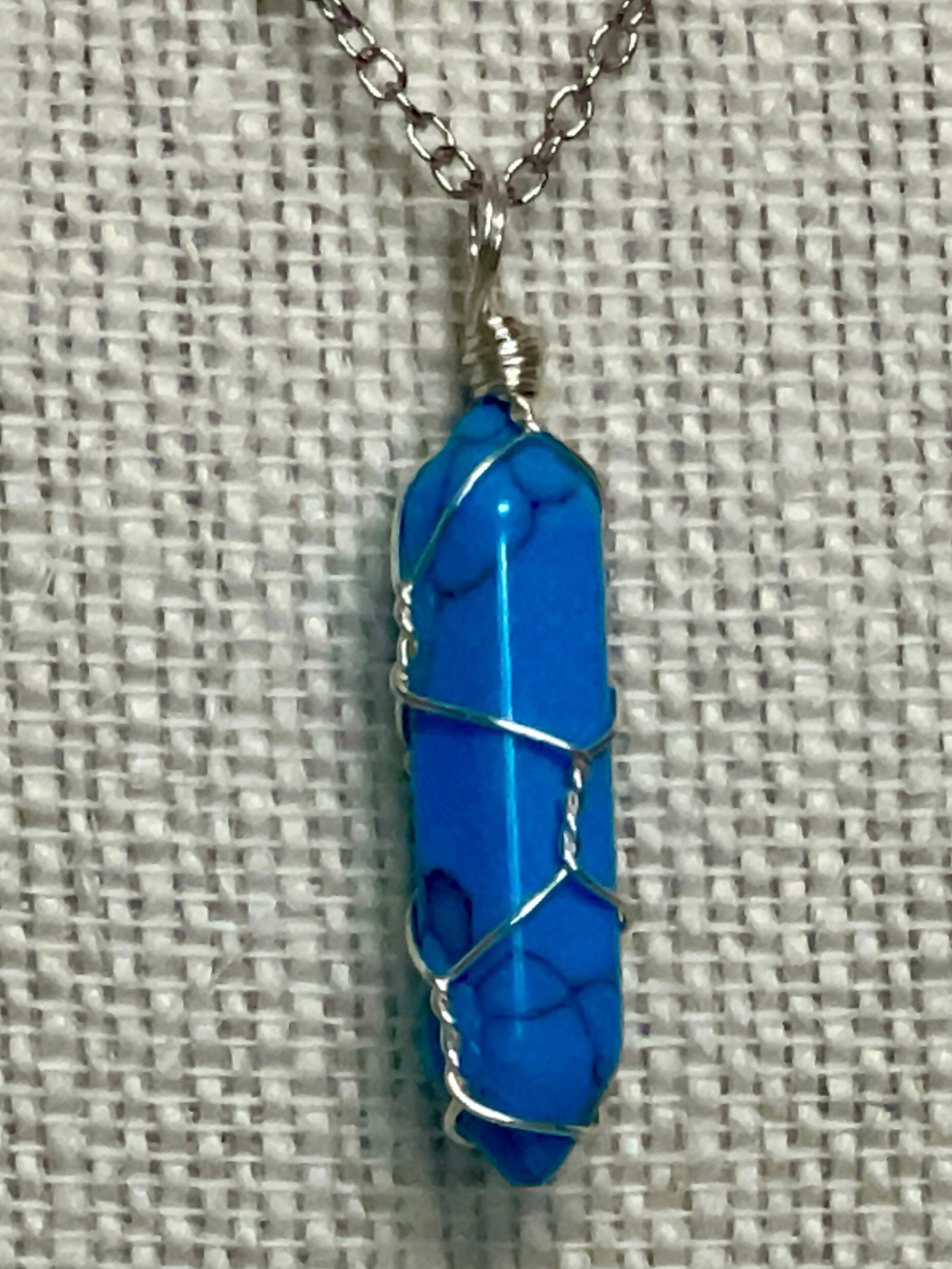 Silver chain necklace with a wire-wrapped 