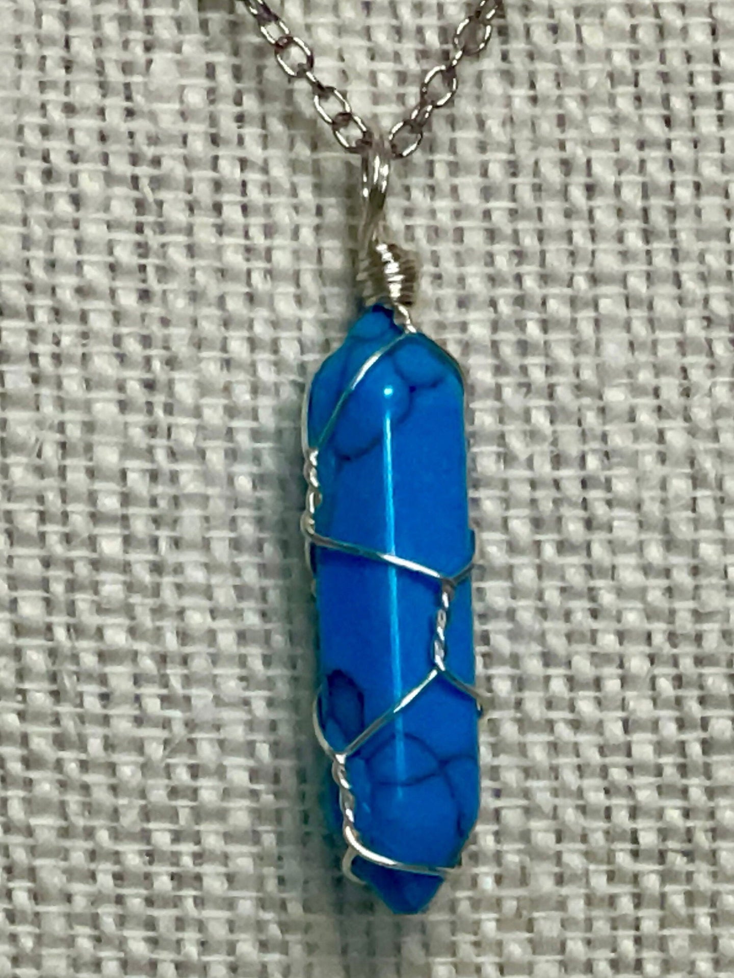 Silver chain necklace with a wire-wrapped 