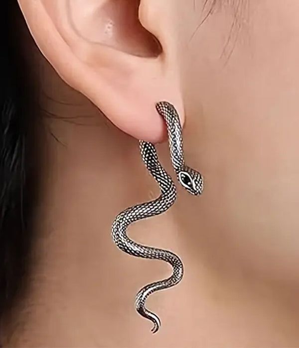 Silver snake dangle earring designed as a coiled snake with detailed scales, hanging from the earlobe for gothic jewelry style.